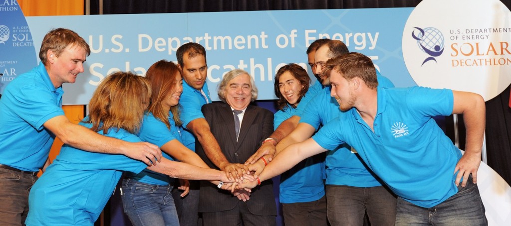 Photo of a group of people stacking their hands on top of each other.
