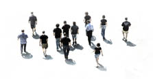 Photo of 12 casually dressed college students walking away from the camera at a distance. The background is white.