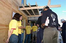 Photo of team members and judges on back porch of house.