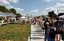Photo of people standing in line and waiting to see inside of house.