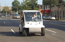 Photo of two people in an electric car.