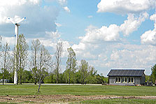 Photo of Crowder's 2005 house near the Nordtank wind turbine on campus.