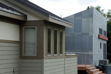 Photo of Missouri University of Science and Technology's 2005 house, in the foreground, with the team's 2007 house, in the background.
